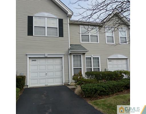 2403 Pheasant Run Monmouth Junction, NJ 08852 - Photo 1 of 10 a front view of a house with a yard