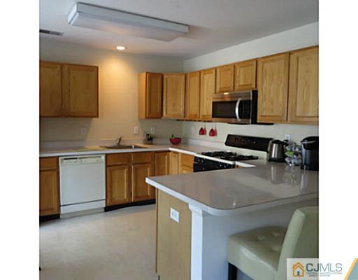 2403 Pheasant Run Monmouth Junction, NJ 08852 - Photo 4 of 10 a kitchen with a sink a stove and cabinets