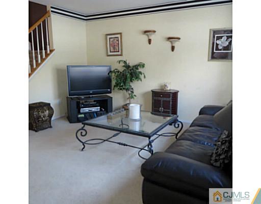 2403 Pheasant Run Monmouth Junction, NJ 08852 - Photo 5 of 10 a living room with furniture and a flat screen tv