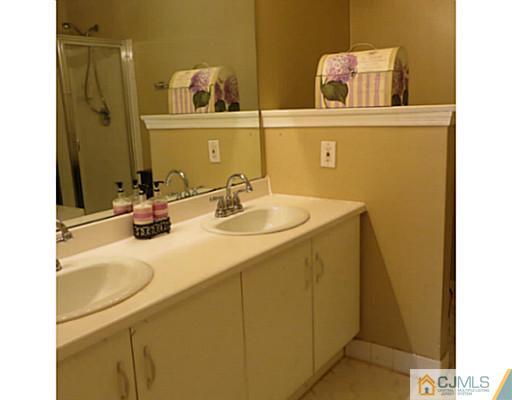 2403 Pheasant Run Monmouth Junction, NJ 08852 - Photo 7 of 10 a bathroom with a sink and a mirror