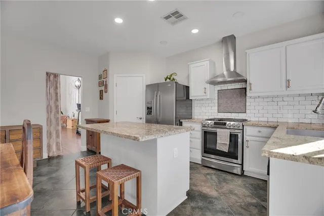a kitchen with cabinets and stainless steel appliances