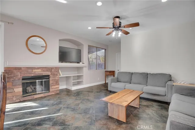 a living room with furniture a fireplace and a flat screen tv
