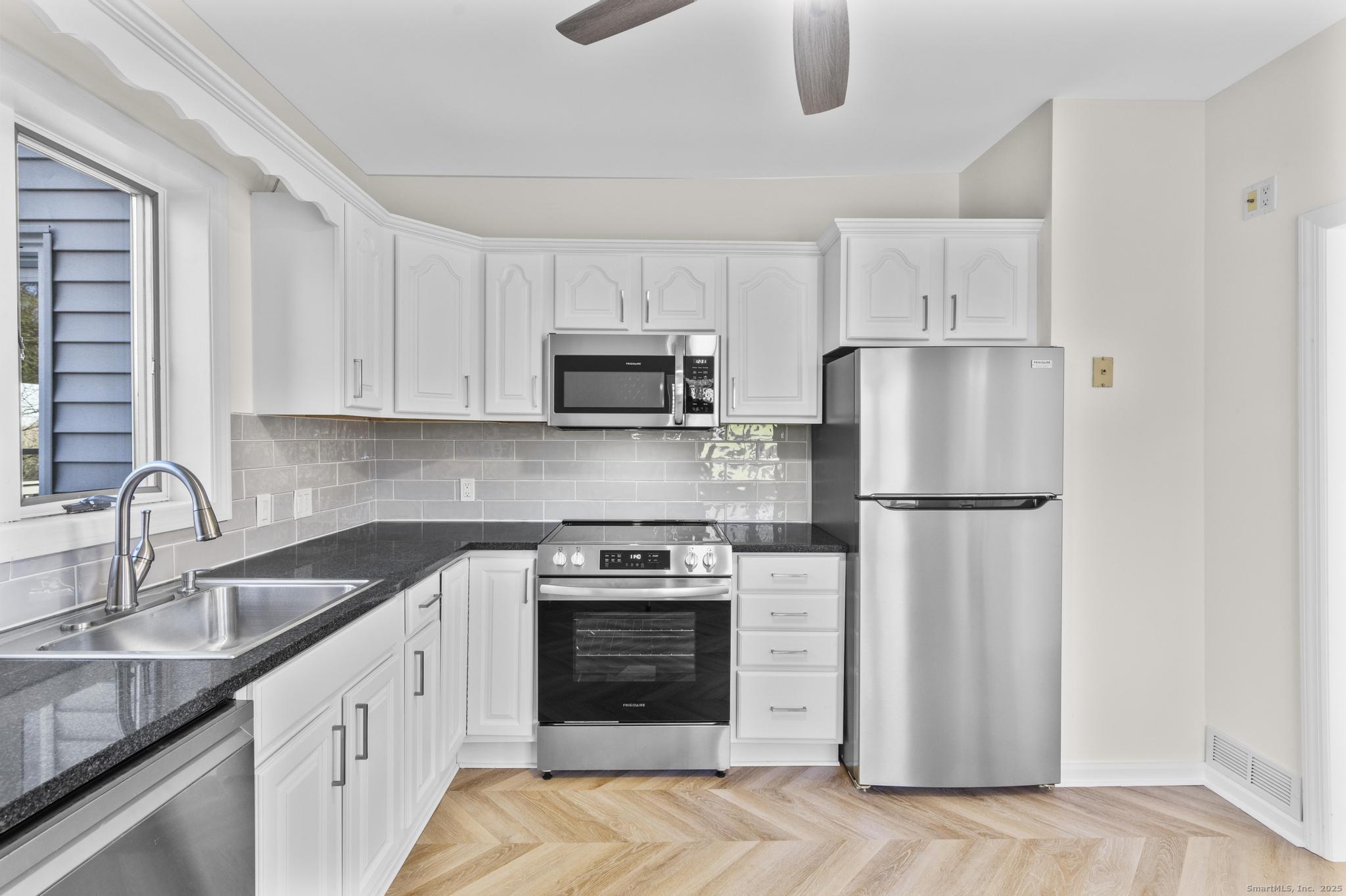4 Bellview Road Branford, CT 06405 - Photo 13 of 30 a kitchen with a sink stove and refrigerator