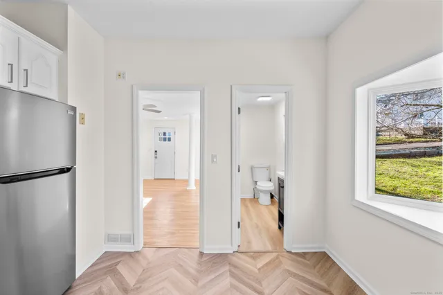 a bathroom with a sink toilet a mirror and vanity