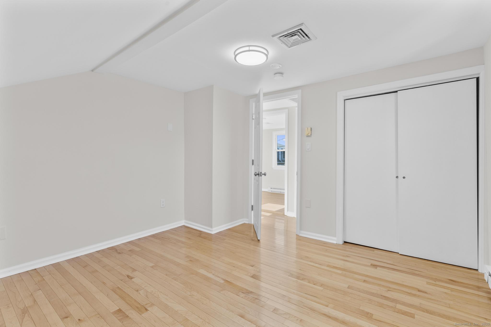 4 Bellview Road Branford, CT 06405 - Photo 16 of 30 a view of an empty room with wooden floor