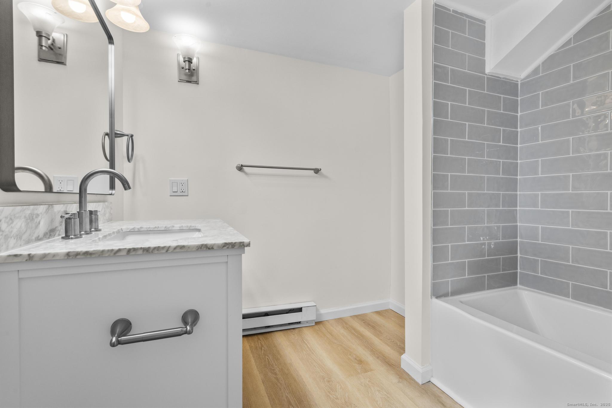 4 Bellview Road Branford, CT 06405 - Photo 17 of 30 a bathroom with a granite countertop sink a toilet and bathtub