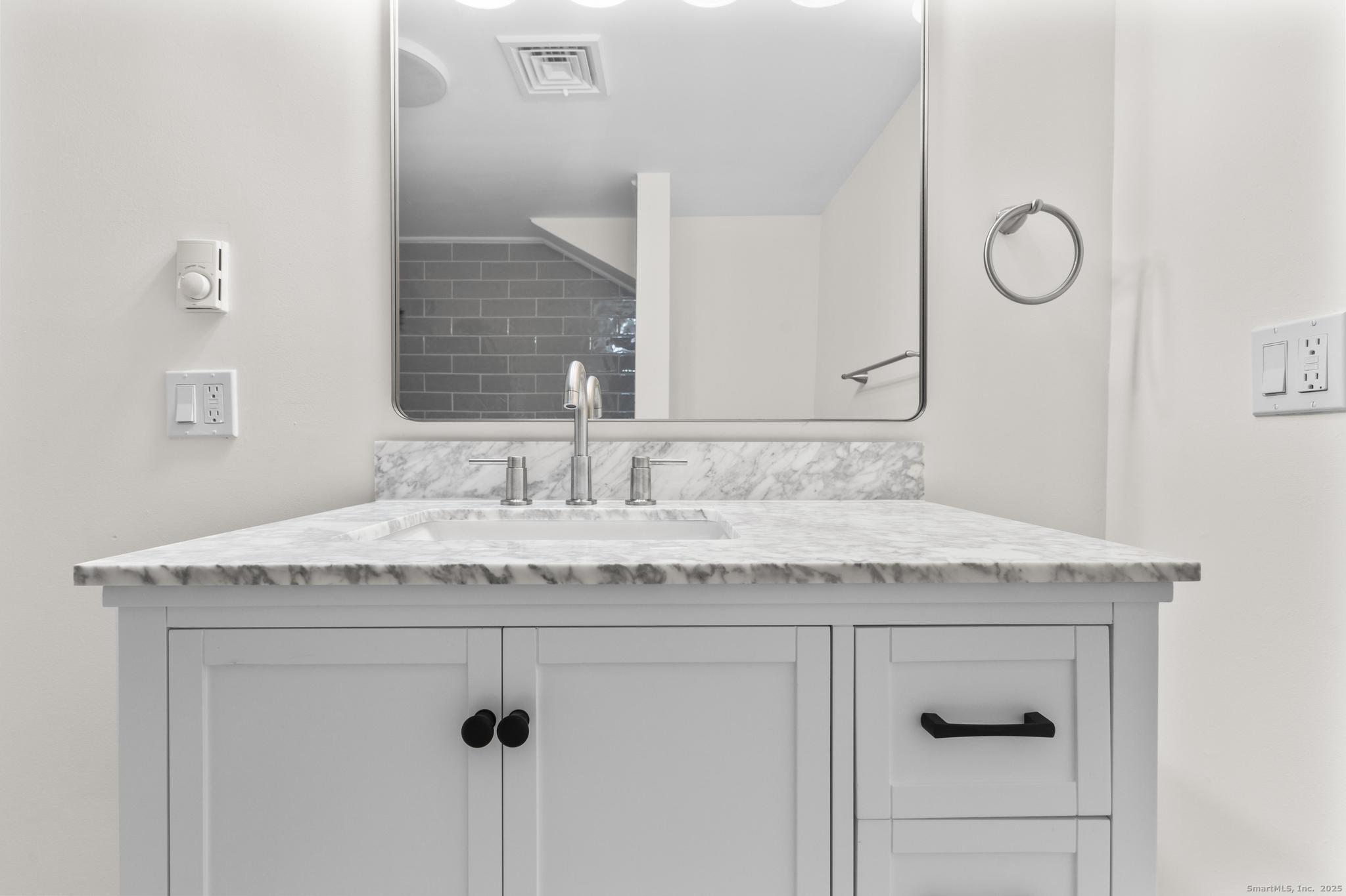 4 Bellview Road Branford, CT 06405 - Photo 18 of 30 a bathroom with a granite countertop sink and a mirror