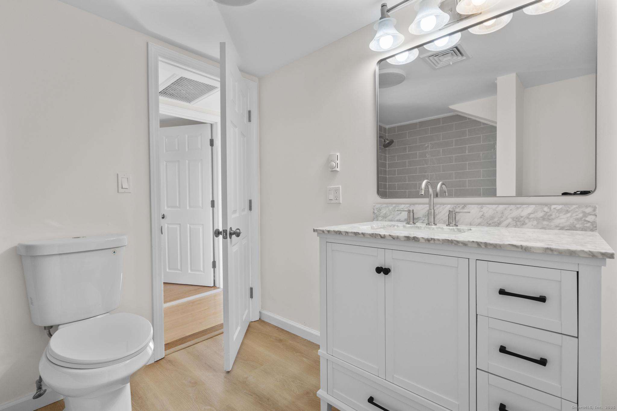 4 Bellview Road Branford, CT 06405 - Photo 20 of 30 a bathroom with a granite countertop sink toilet and shower