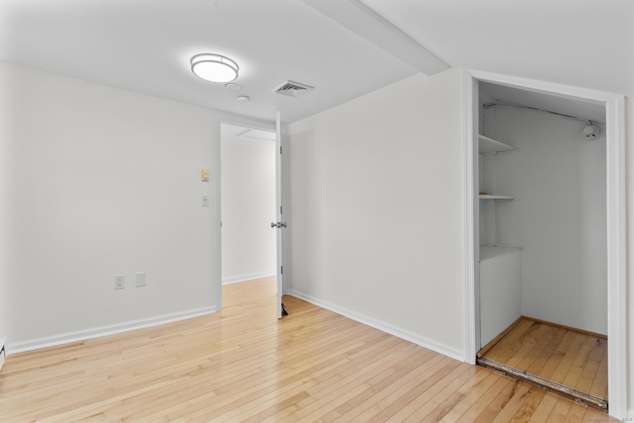 4 Bellview Road Branford, CT 06405 - Photo 21 of 30 an empty room with wooden floor