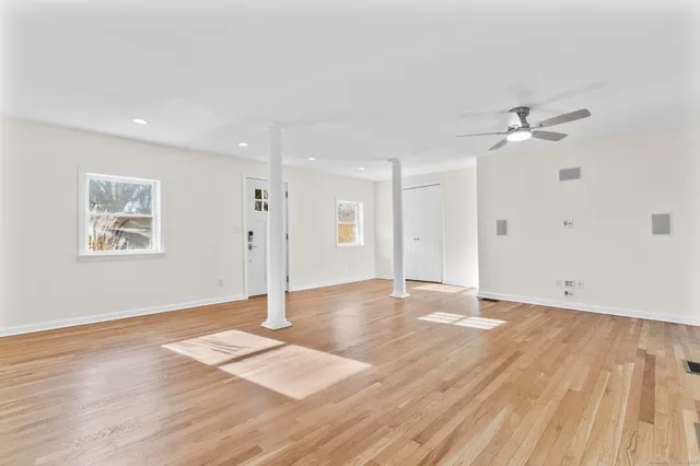 a view of an empty room and wooden floor