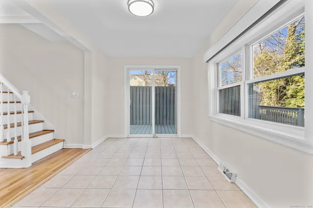 an empty room with staircase and white walls
