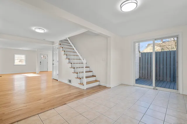 a kitchen with white cabinets stainless steel appliances and a refrigerator