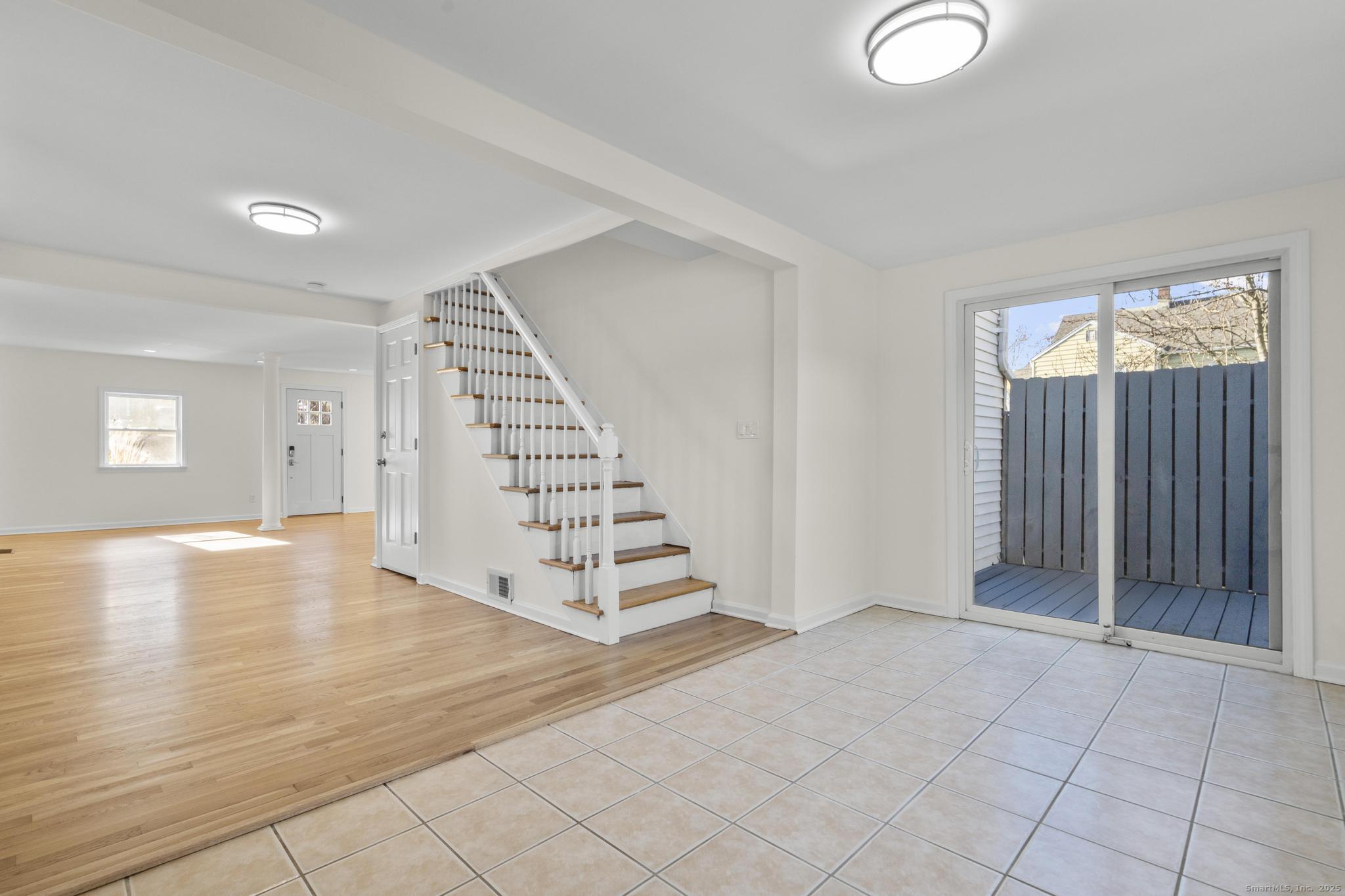 4 Bellview Road Branford, CT 06405 - Photo 9 of 30 an empty room with staircase and white walls