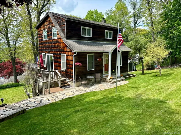 a view of a house with a yard and porch