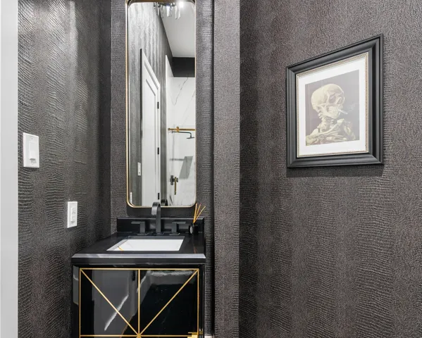 a bathroom with a sink a mirror and a window