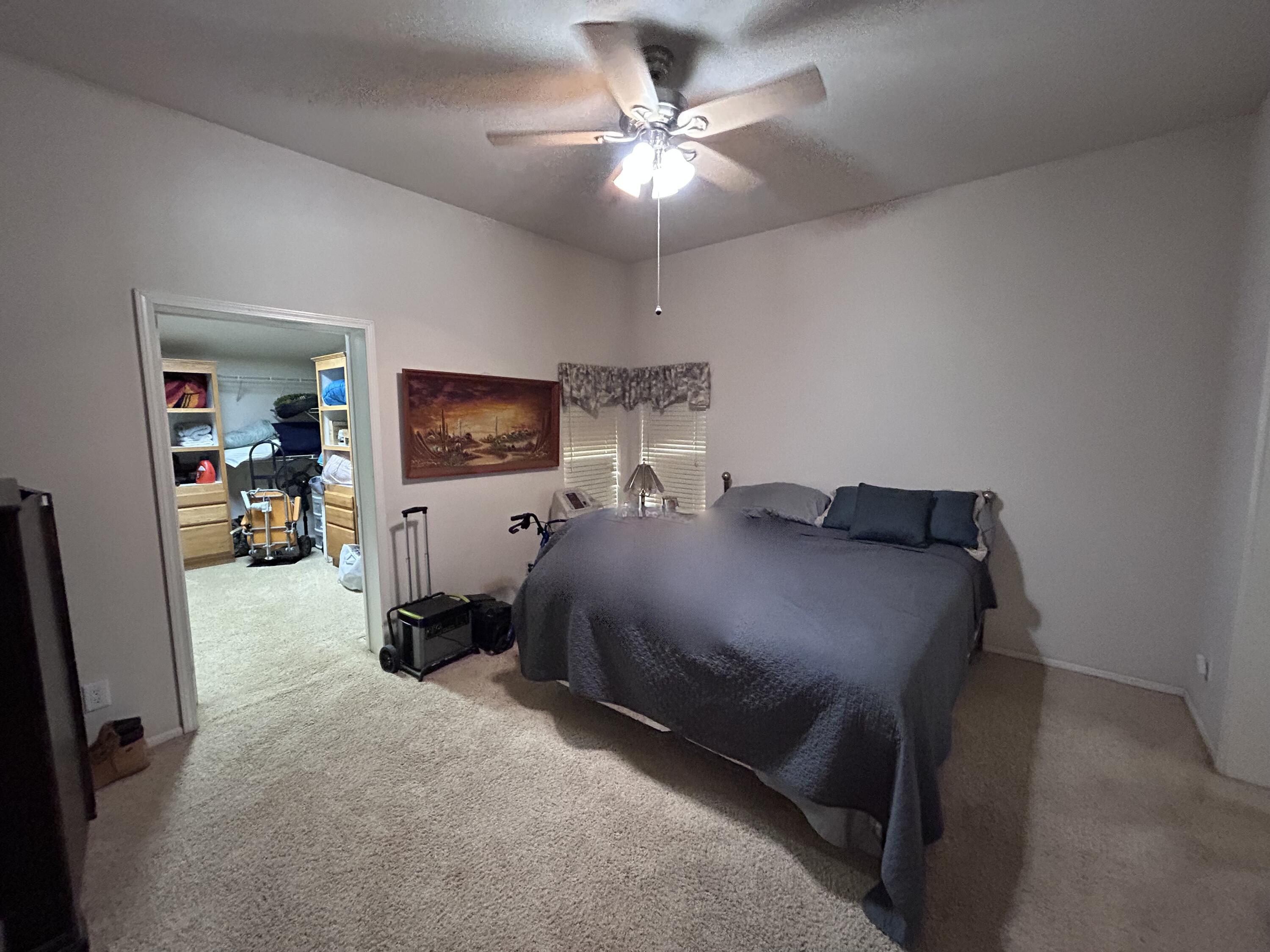 7150 Kaysie Rae Court Shingletown, CA 96088 - Photo 12 of 34 a bed room with a bed and a chandelier