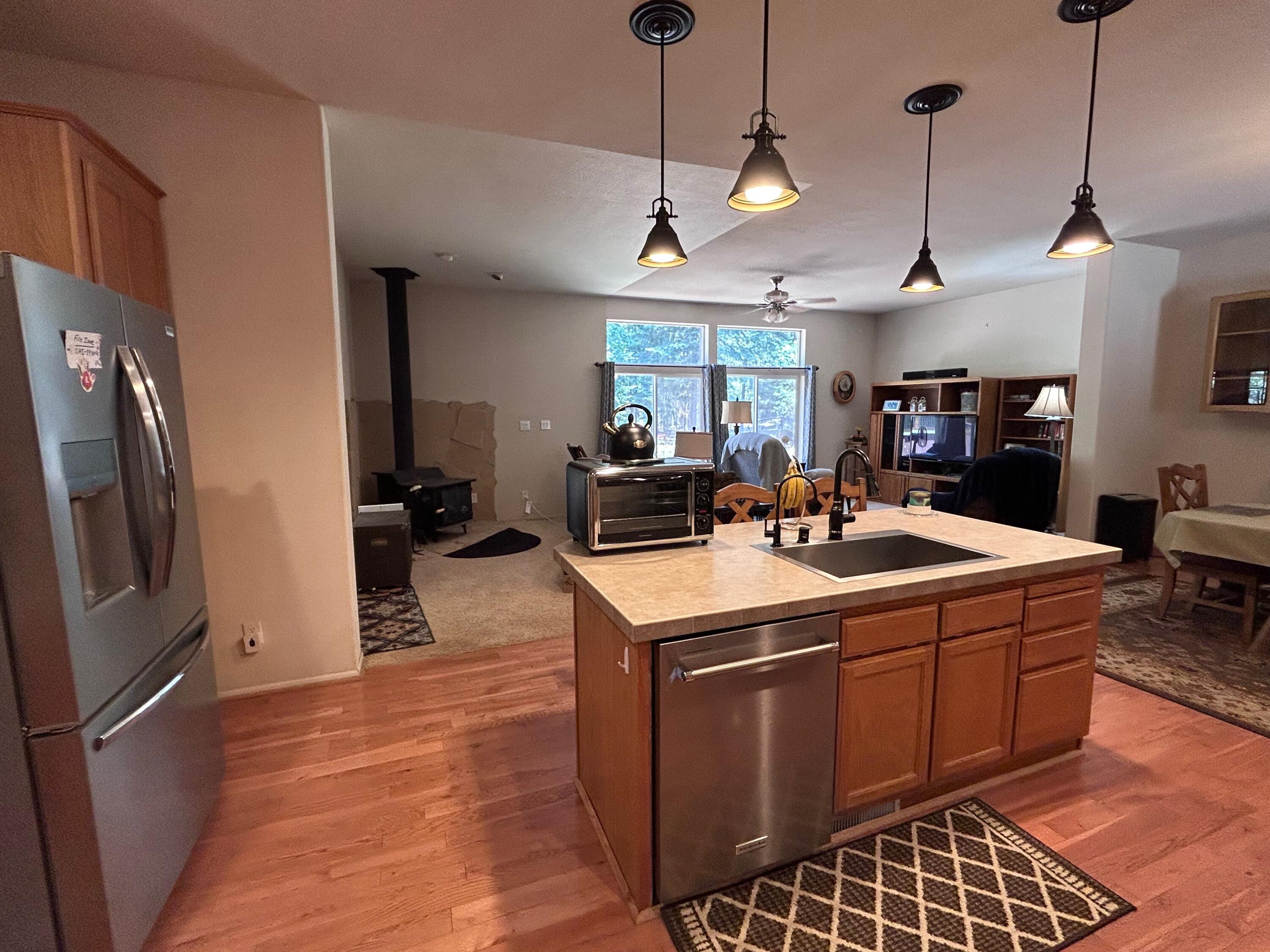 7150 Kaysie Rae Court Shingletown, CA 96088 - Photo 5 of 34 a kitchen with a sink a counter top space stainless steel appliances and a chandelier