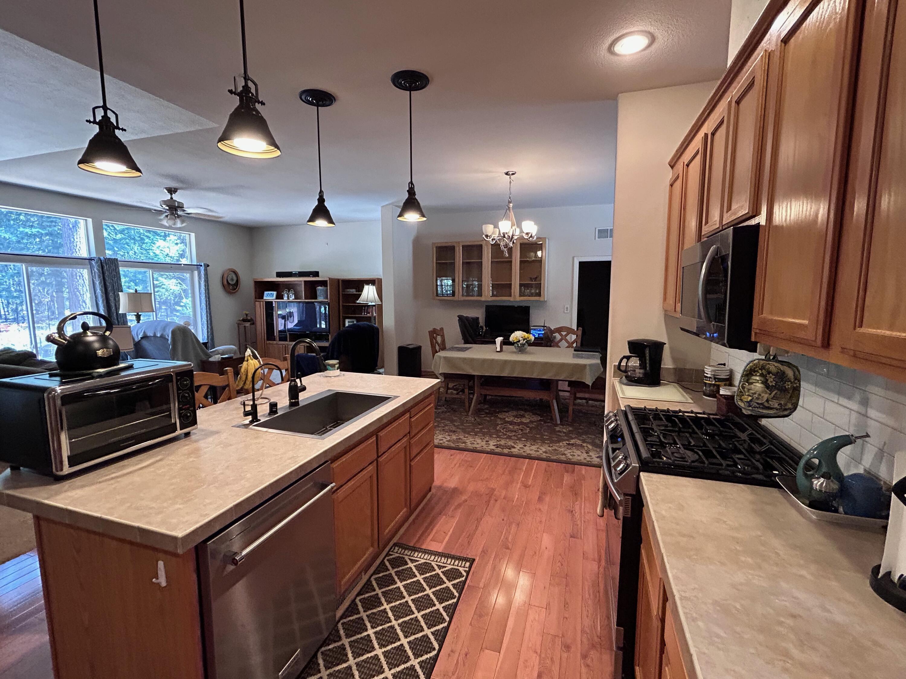 7150 Kaysie Rae Court Shingletown, CA 96088 - Photo 6 of 34 a kitchen with a stove and a wooden floor