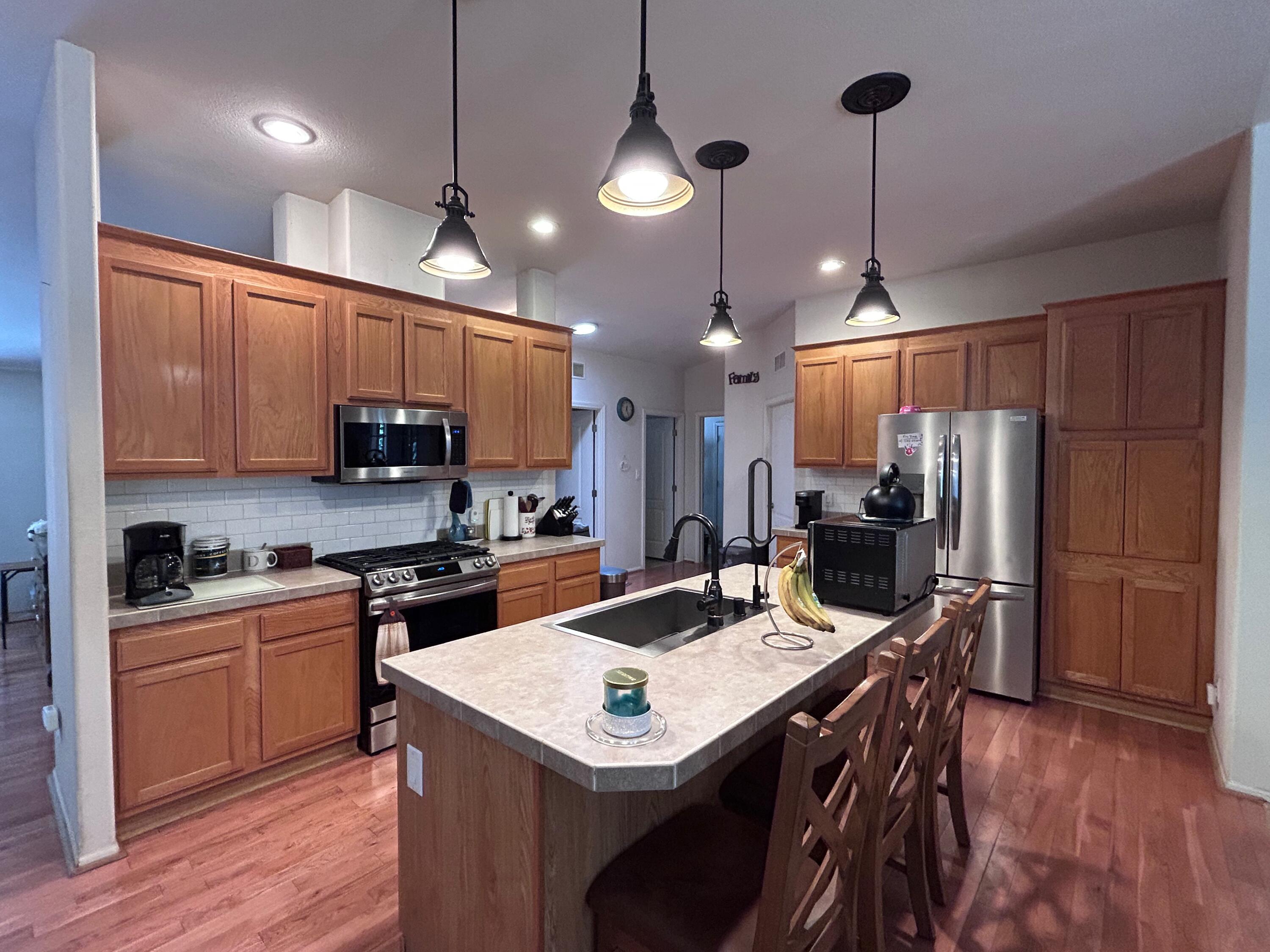 7150 Kaysie Rae Court Shingletown, CA 96088 - Photo 7 of 34 a kitchen with kitchen island a sink stove and refrigerator