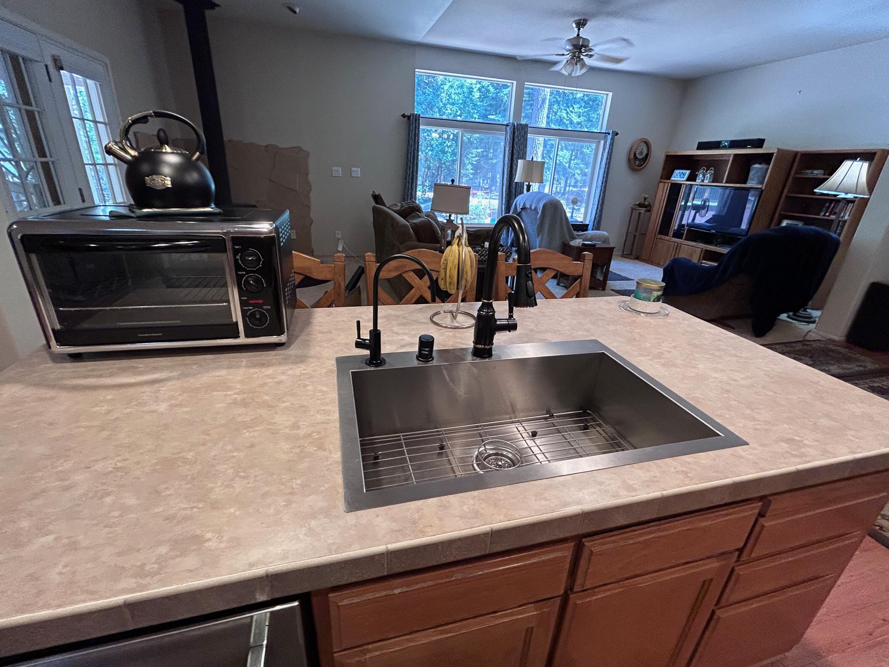 7150 Kaysie Rae Court Shingletown, CA 96088 - Photo 8 of 34 a kitchen with sink a stove and cabinets