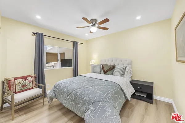a bedroom with a bed and a couch