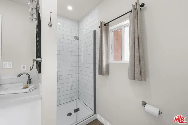 a bathroom with a shower bathtub and a window