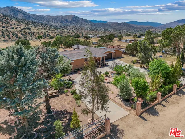 an aerial view of a house with a garden
