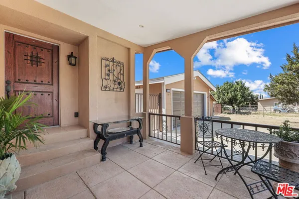 a view of a chairs and table in a patio