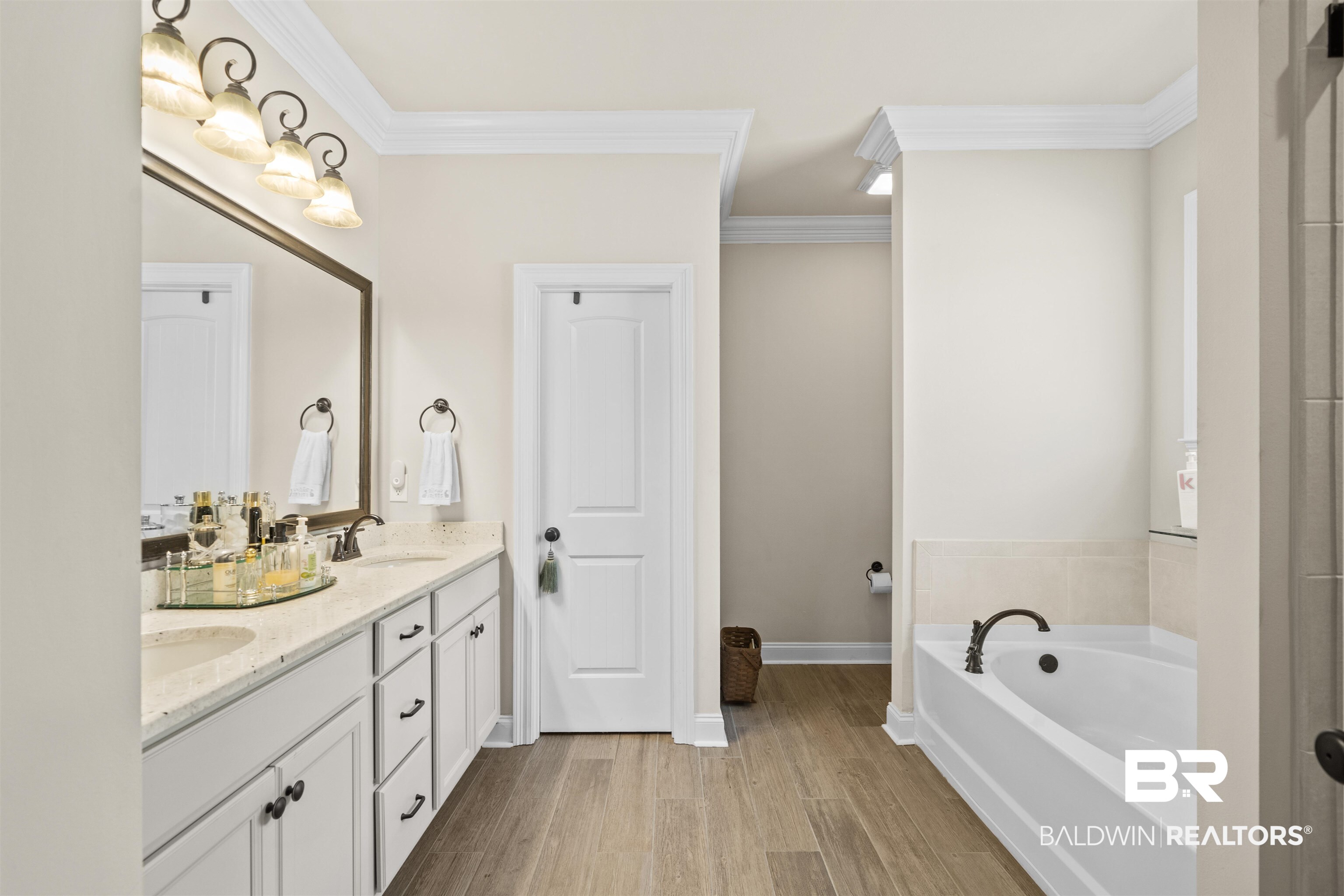 1509 Fenton Circle Foley, AL 36535 - Photo 23 of 34 Full bathroom featuring double vanity, ornamental molding, a garden tub, and wood finished floors