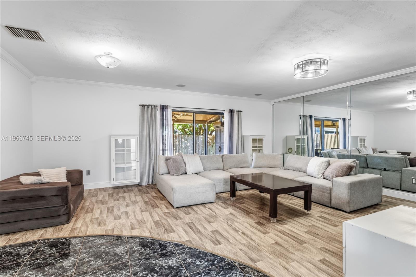 11753 Southwest 197th Street Miami, FL 33177 - Photo 12 of 36 a living room with furniture and a couch