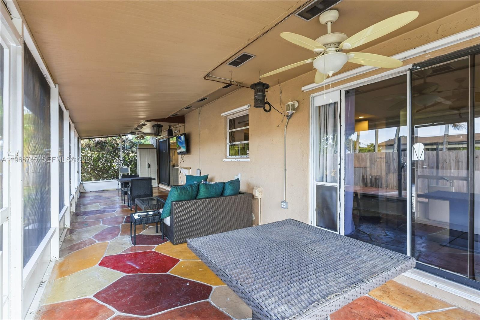 11753 Southwest 197th Street Miami, FL 33177 - Photo 17 of 36 a living room with a rug floor to ceiling window and furniture