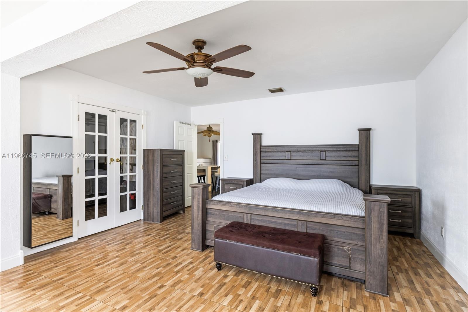 11753 Southwest 197th Street Miami, FL 33177 - Photo 20 of 36 a bedroom with a bed and a chandelier