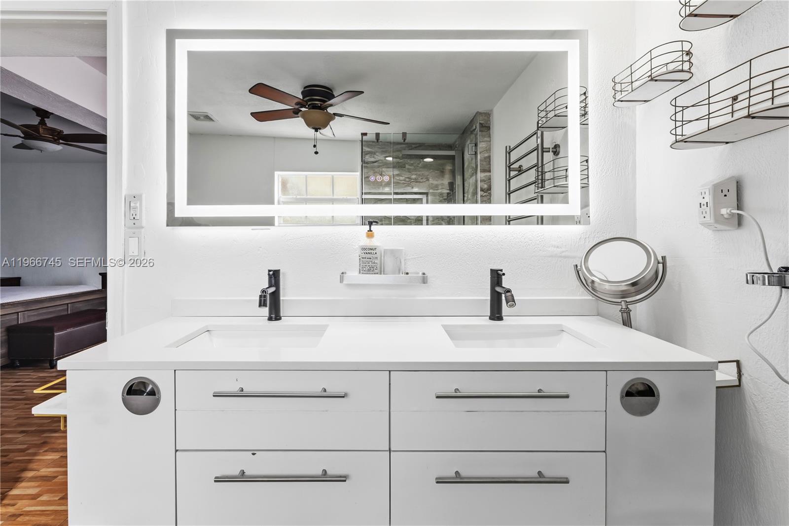11753 Southwest 197th Street Miami, FL 33177 - Photo 21 of 36 a bathroom with a sink and a mirror