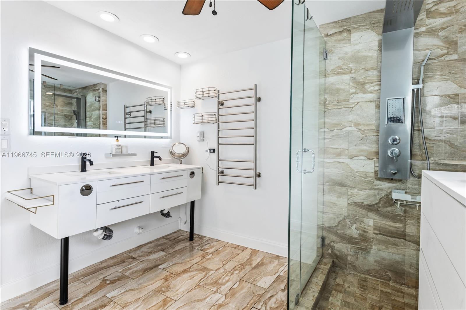11753 Southwest 197th Street Miami, FL 33177 - Photo 22 of 36 a bathroom with a sink mirror and shower