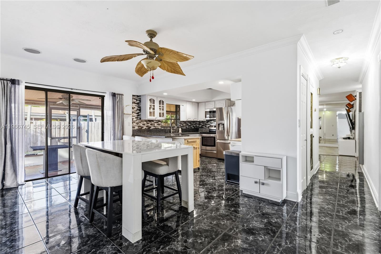 11753 Southwest 197th Street Miami, FL 33177 - Photo 3 of 36 a view of kitchen and dining area with chandelier