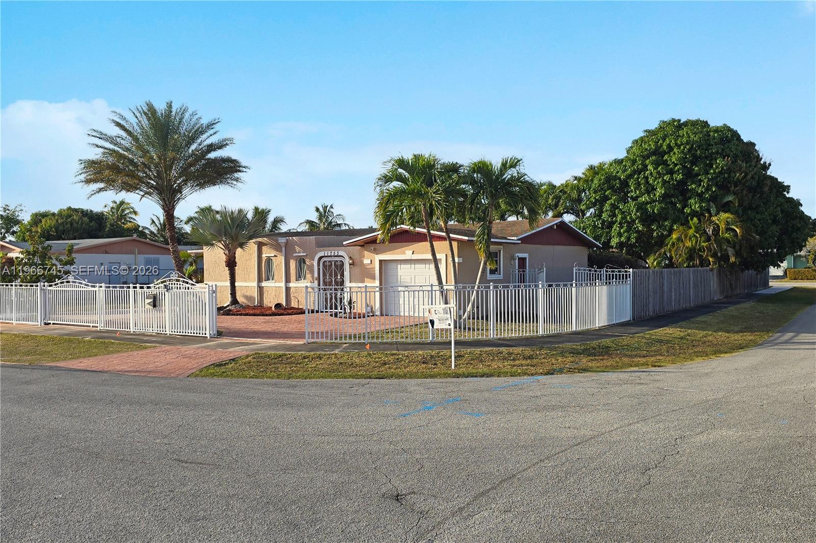 11753 Southwest 197th Street Miami, FL 33177 - Photo 36 of 36 a view of a house with a yard and palm trees