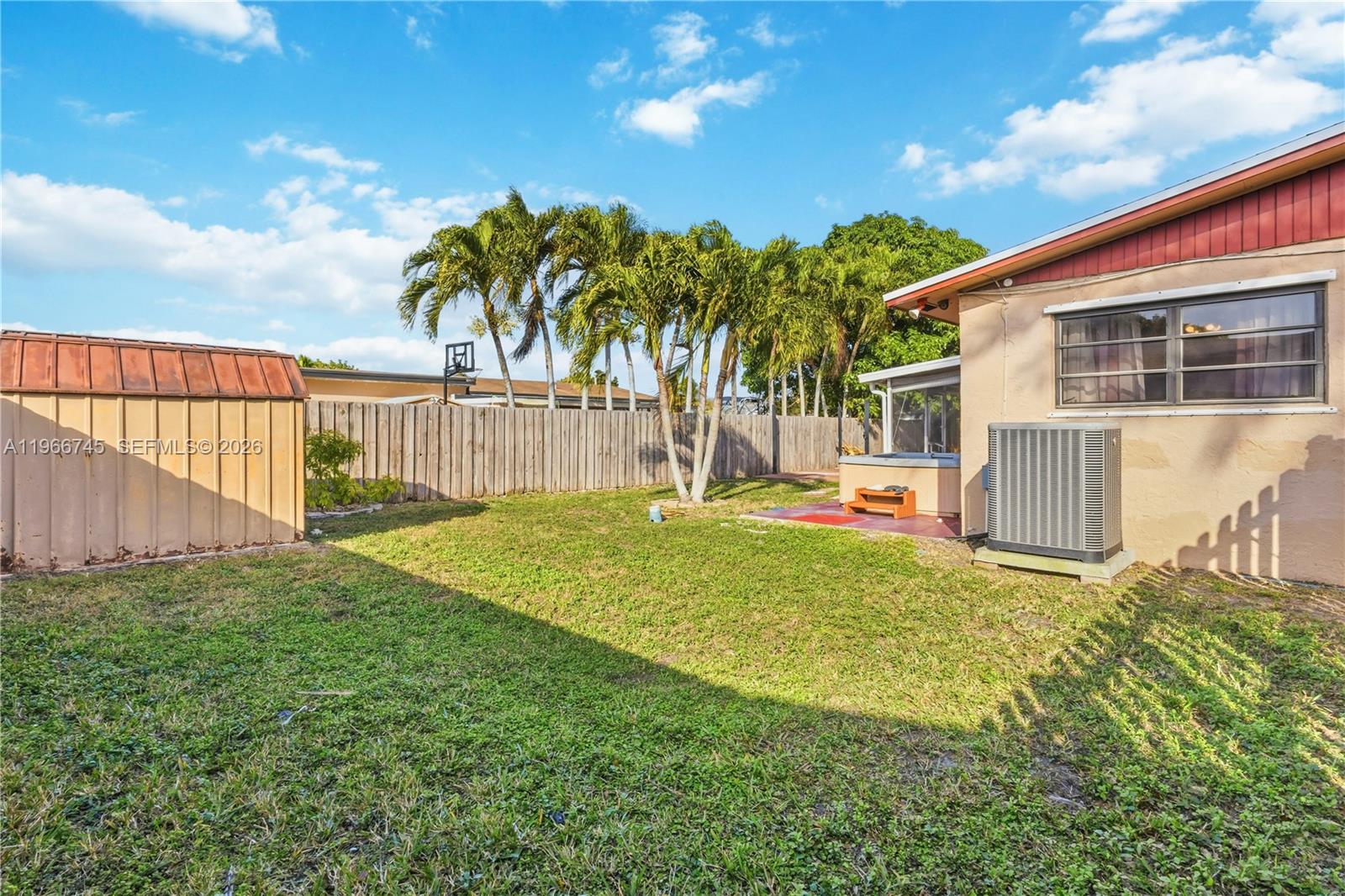 11753 Southwest 197th Street Miami, FL 33177 - Photo 5 of 36 a backyard of a house with table and chairs