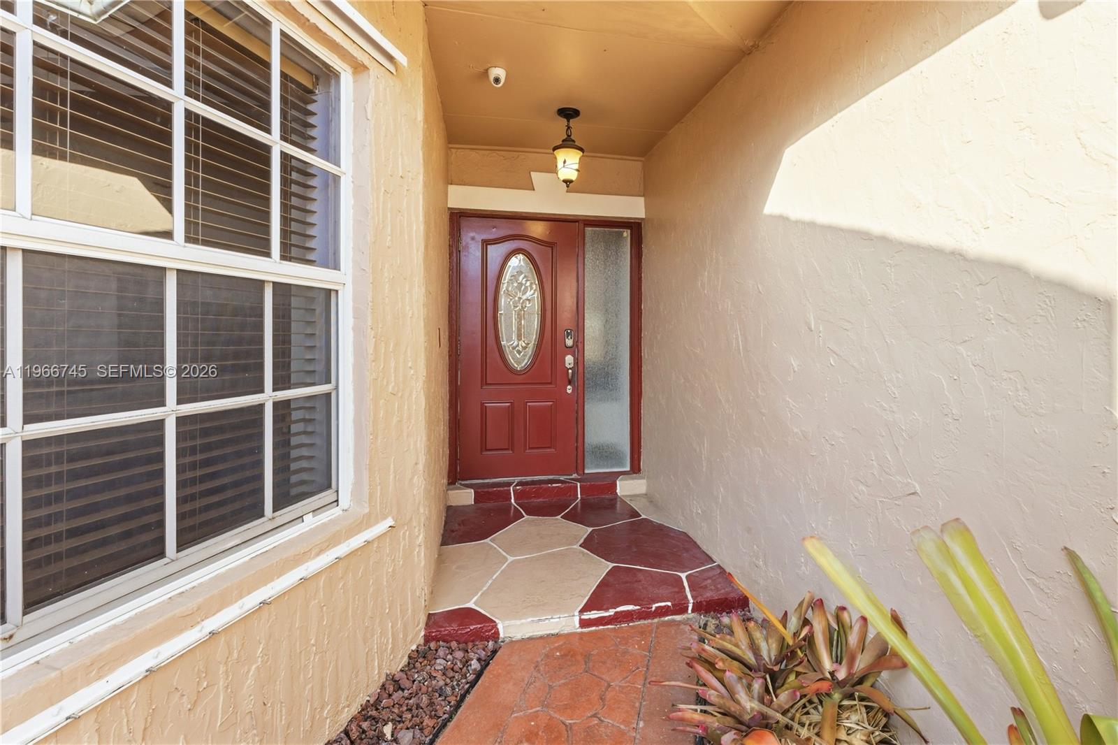 11753 Southwest 197th Street Miami, FL 33177 - Photo 6 of 36 a front view of a house with entryway