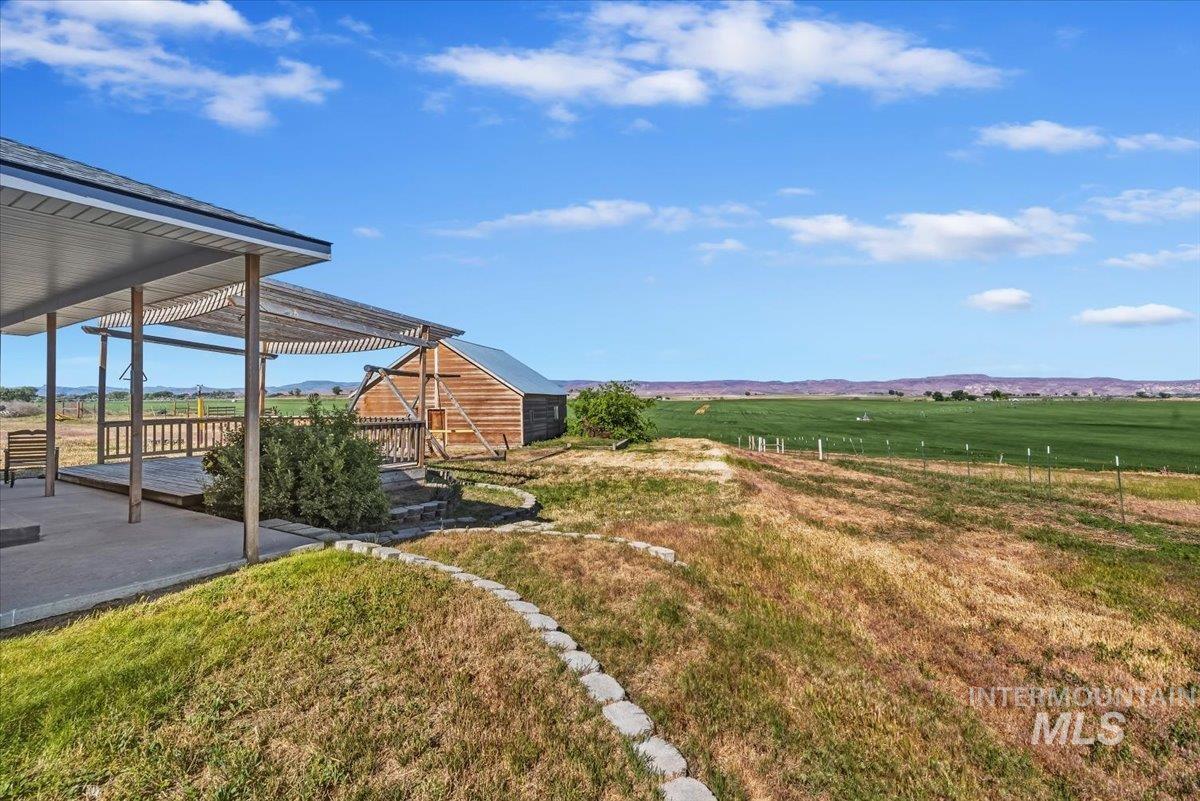 2331 Gulley Road Homedale, ID 83628 - Photo 40 of 46 Covered patio with a slatted pergola roof, a concrete slab, and a wood-railed deck
