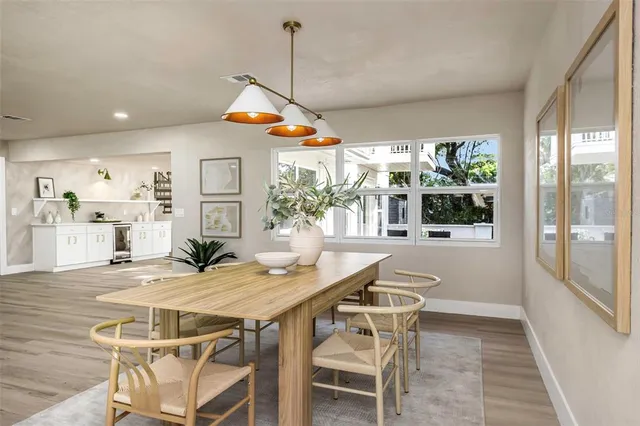 a view of a kitchen with kitchen island stainless steel appliances a sink and living room view