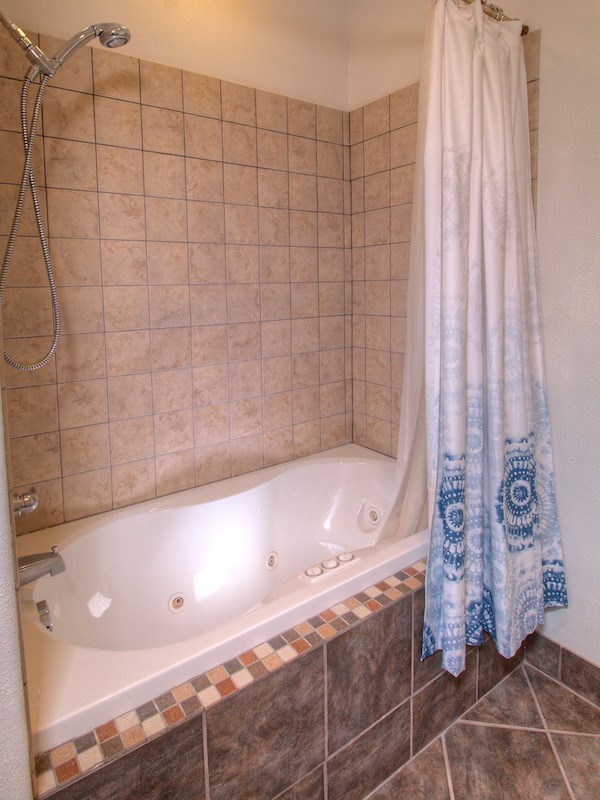 2550 I Road Grand Junction, CO 81505 - Photo 14 of 34 a bathroom with a bathtub and shower
