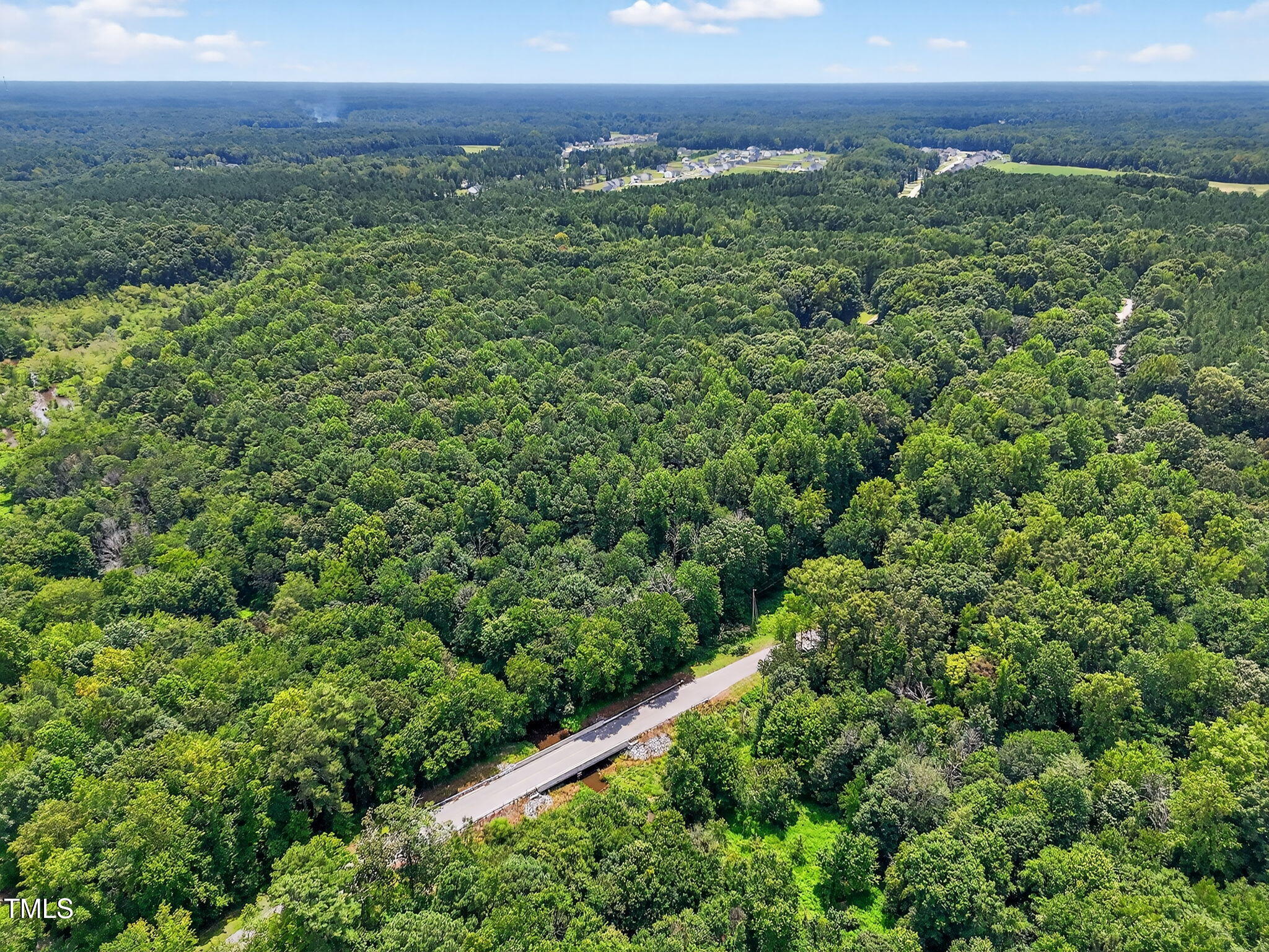0 Eatmon Road Zebulon, NC 27597 - Photo 6 of 13 an aerial view of a houses with a lush green hillside
