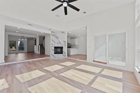 a view of an empty room with a fireplace and a window