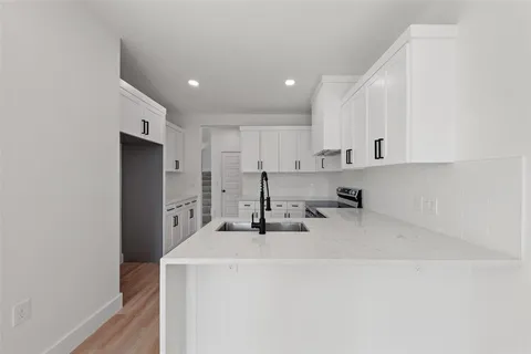 a kitchen with a sink a stove and a refrigerator