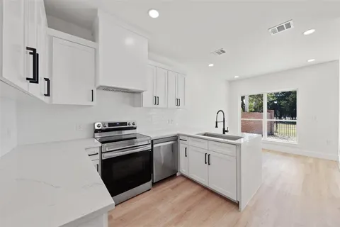 a kitchen with a stove and a sink
