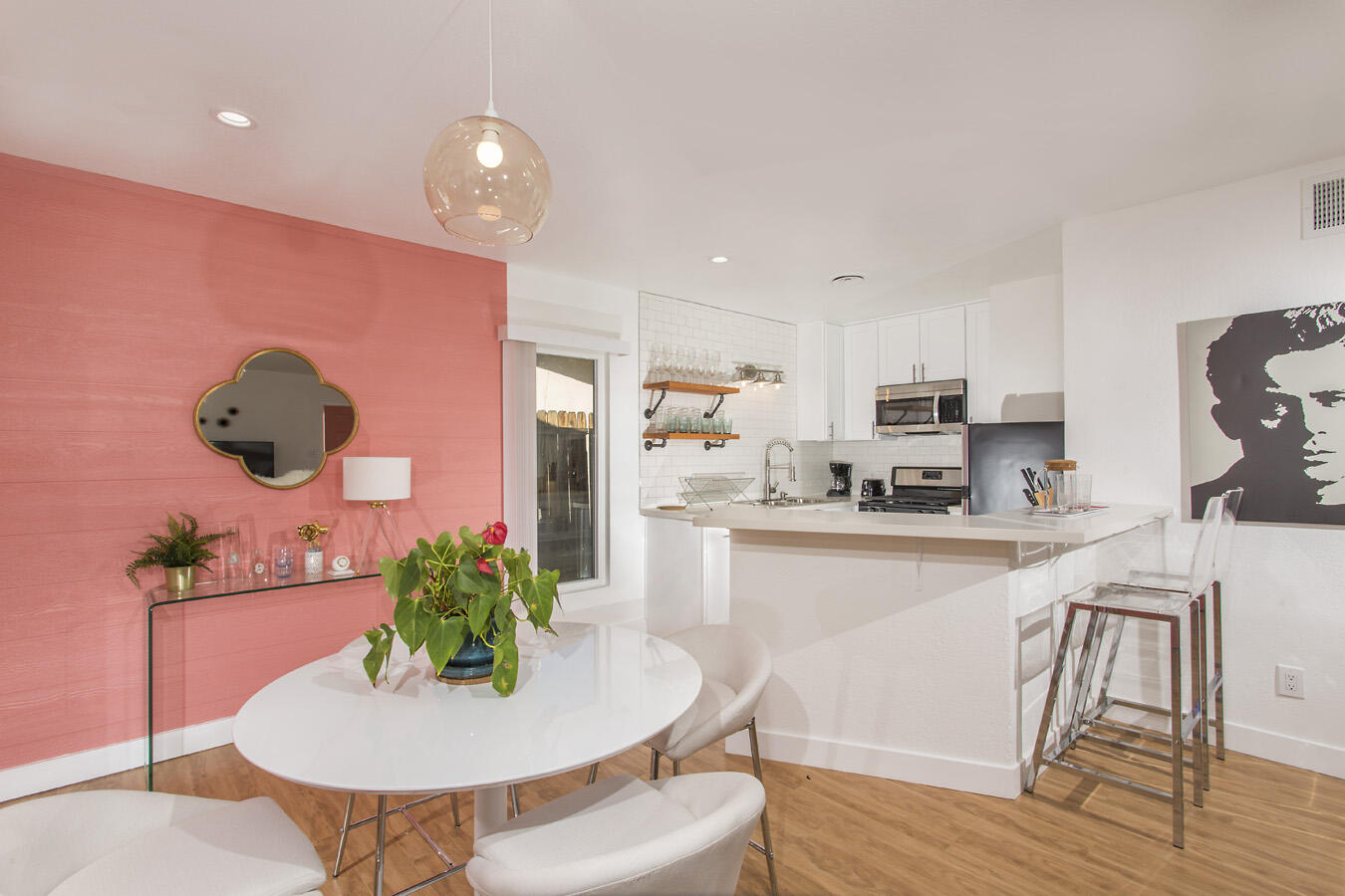 68080 Risueno Road Cathedral City, CA 92234 - Photo 37 of 98 a kitchen with stainless steel appliances granite countertop a kitchen island hardwood floor sink stove dining table and chairs