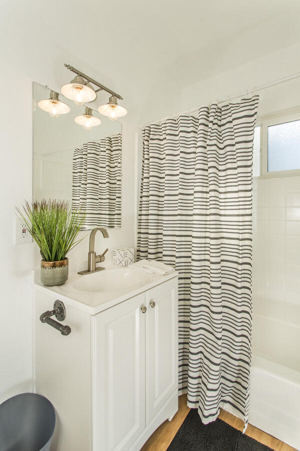 68080 Risueno Road Cathedral City, CA 92234 - Photo 48 of 98 a bathroom with a sink a mirror and a shower