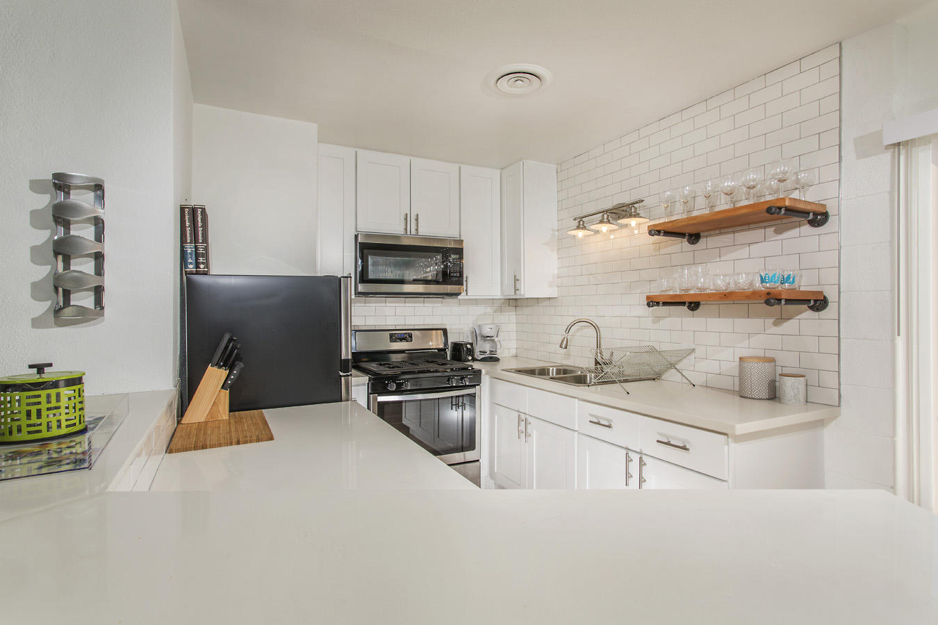 68080 Risueno Road Cathedral City, CA 92234 - Photo 66 of 98 a kitchen with stainless steel appliances a sink a stove a refrigerator cabinets and a refrigerator