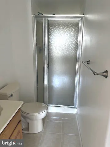 a bathroom with a glass shower door