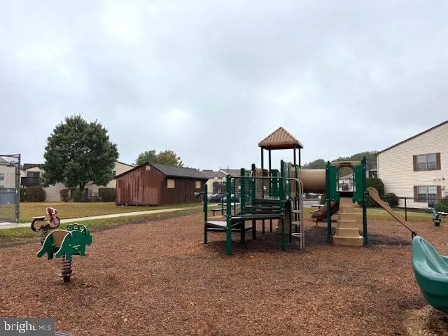 a backyard of a house with barbeque oven table and chairs